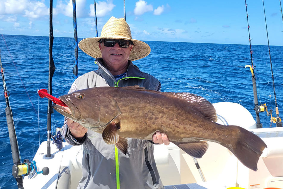 Tim Barefoot with a Grouper caught with a 12 oz Tuna Decoy Jig